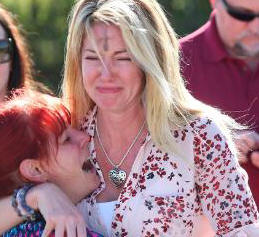 Parents wait for news after a reports of a shooting at Marjory Stoneman Douglas High School in Parkland, Fla., on Wednesday, Feb. 14, 2018. (AP Photo/Joel Auerbach)