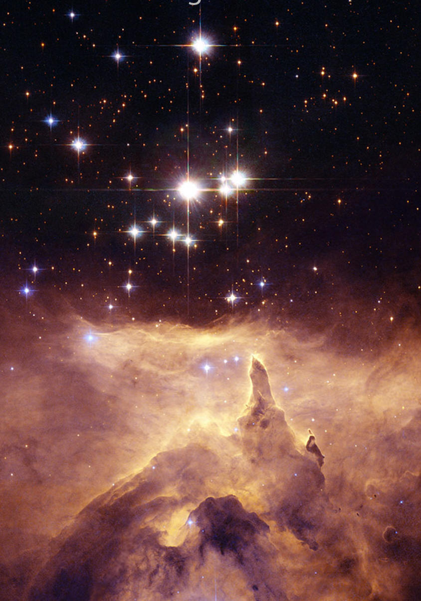 Stars dot the frame that has a blue background.
Covering the lower part of the image, and the far
right, are brown and tan nebular structures.  
Please see the explanation for more detailed information.