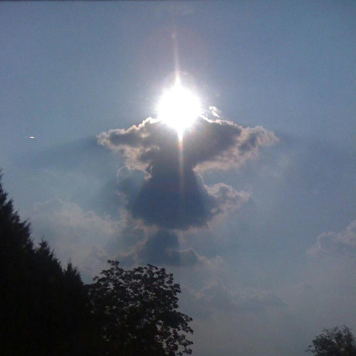 This may contain: the sun is shining brightly through the clouds